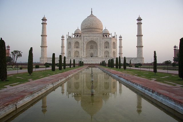 Taj Mahal reflected in the long rectangular pool at sunrise, Agra